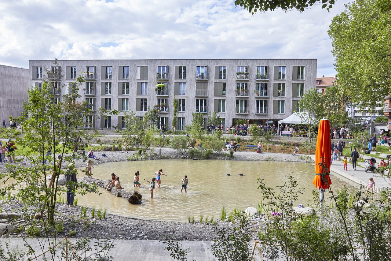 Menschen stehen in einem grossen Wasserbecken.